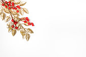 Golden mistletoe leaf over white background. Christmas theme. Copy space.