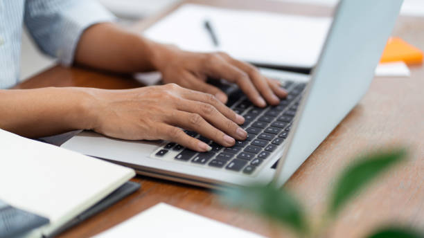 istock hands close up Freelancer busy working on a laptop computer on desktop 1277468915