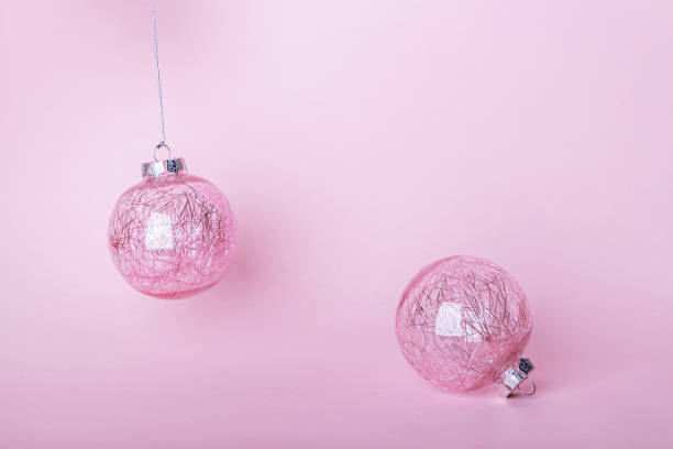 istock Christmas composition. Two Christmas pink bauble, shiny balls hanging on pastel background. Mock up for new year gretting card. Close up, copy space for text or lettering 1277475988