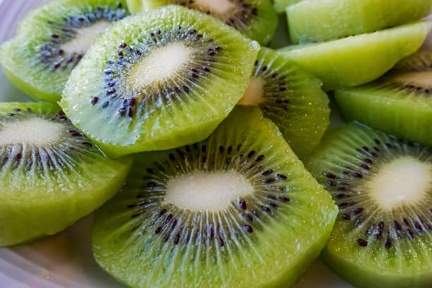 istock close up sliced kiwi fruits on white plate 1277477702