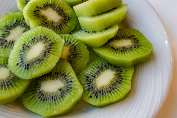 istock close up sliced kiwi fruits on white plate 1277477778