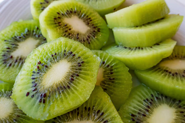 istock close up sliced kiwi fruits on white plate 1277478008