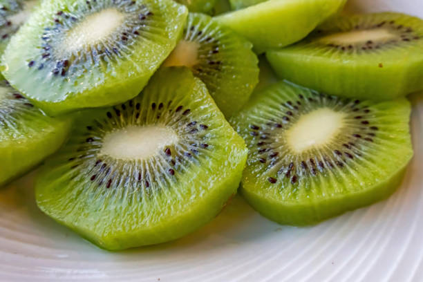 istock close up sliced kiwi fruits on white plate 1277478051