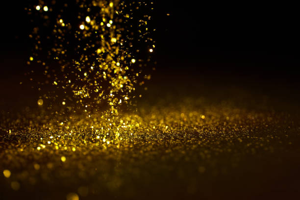 istock Sparkling golden glittering effect isolated on black background. 1277478870