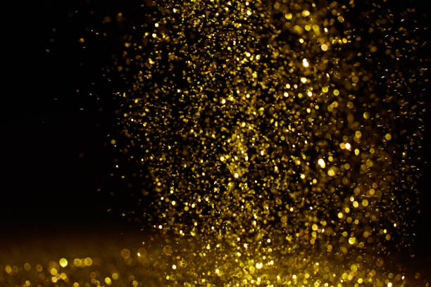 istock Sparkling golden glittering effect isolated on black background. 1277478891