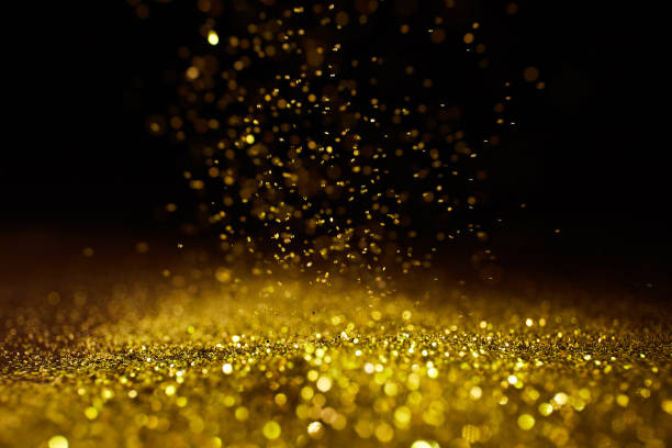 istock Sparkling golden glittering effect isolated on black background. 1277478904