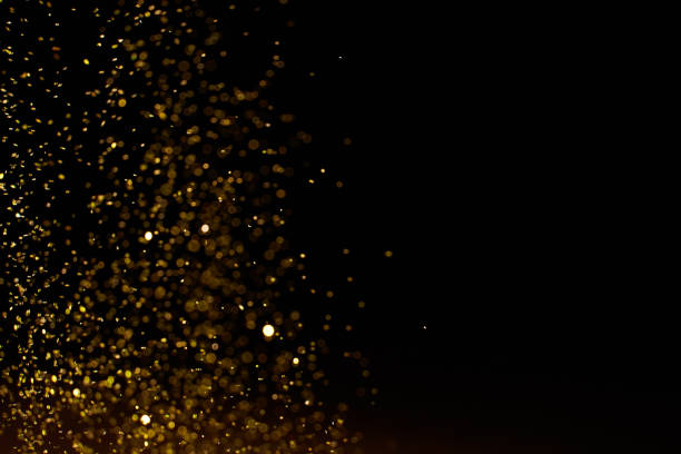istock Sparkling golden glittering effect isolated on black background. 1277478942