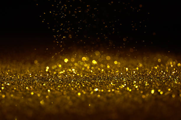istock Sparkling golden glittering effect isolated on black background. 1277478966