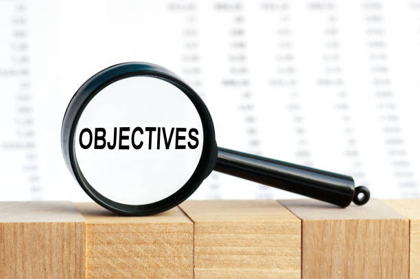 istock Look closely and OBJECTIVES with a magnifying glass , business concept image with soft focus background 1277481566