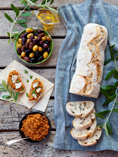 Ciabatta bread bruschetta with olive tapenade. Wooden background. Top view.