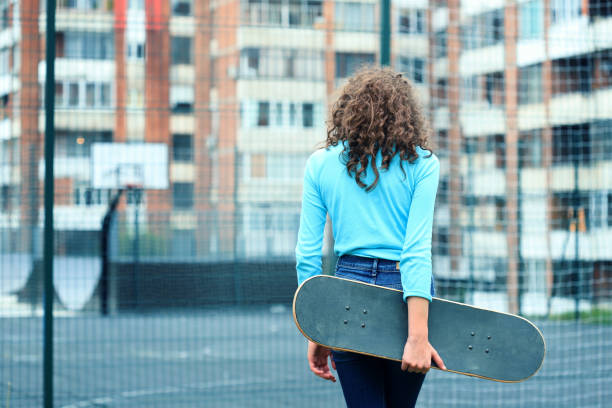 istock Girl holding a skateboard 1277482864