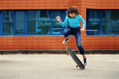 Teenage girl having fun while skateboarding