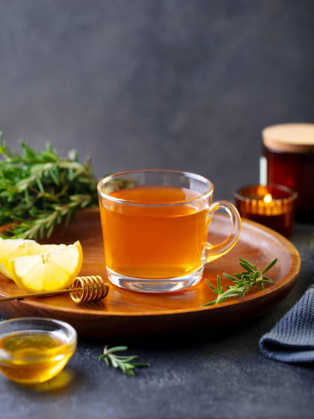 teetasse mit rosmarin, honig und zitrone. grauer hintergrund. kopieren sie den speicherplatz. - homewares rustic herbal tea herb stock-fotos und bilder