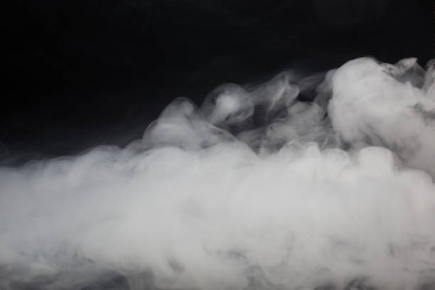 istock Cloud of white smoke on a black background closeup 1277484988