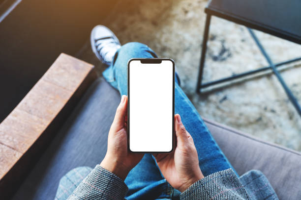 istock a woman holding mobile phone with blank white desktop screen 1277485422