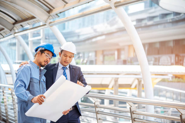 istock Civil construction engineer team meeting on construction site with teamwork wear safety suit trust team look at blue print on table consulting together safety hard hat construction engineer concept 1277487243