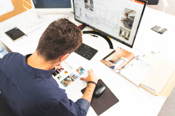 A young male architect working on a project in his office