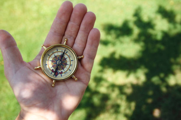 istock Man hold compass in nature background for journey trip 1277488420