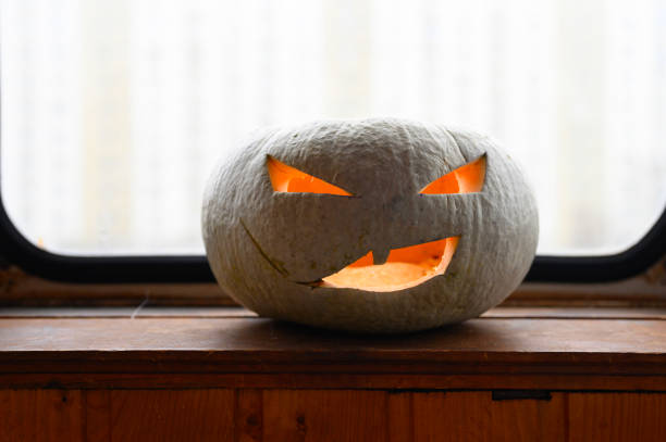 istock glowing spooky Halloween pumpkin at home on the table 1277488525