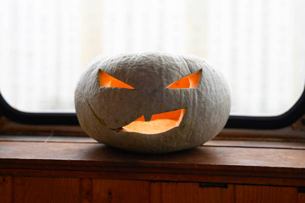 istock glowing spooky Halloween pumpkin at home on the table 1277488526