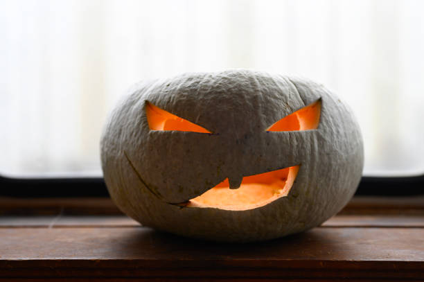 istock glowing spooky Halloween pumpkin at home on the table 1277488527