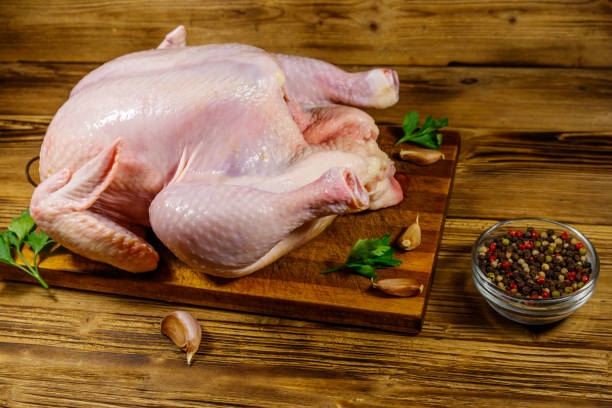 istock Raw whole chicken with spices on a wooden table 1277491169