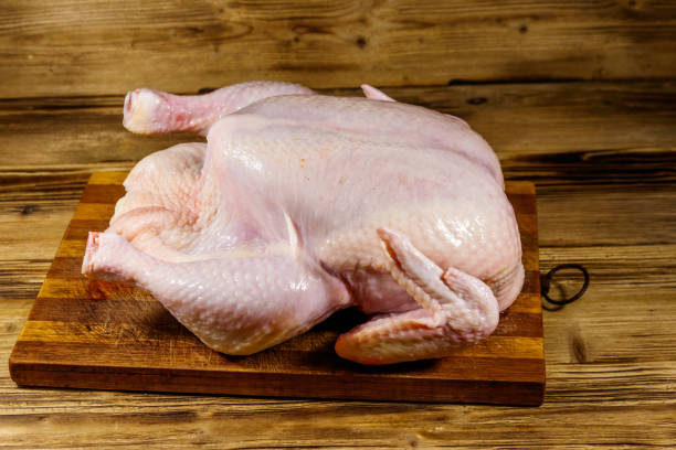 istock Raw whole chicken on a wooden table 1277491171