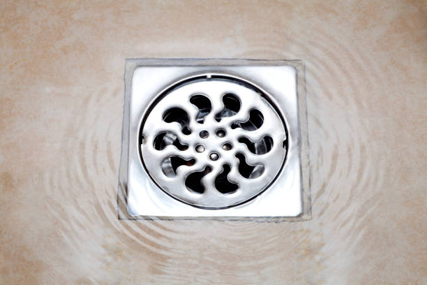 water flowing over into metal drain water flowing over into metal drain on the tiled floor of a shower drainage photos stock pictures, royalty-free photos & images