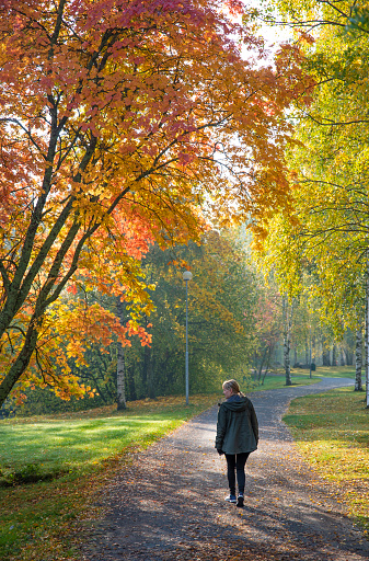 Woman walking in park in autumn