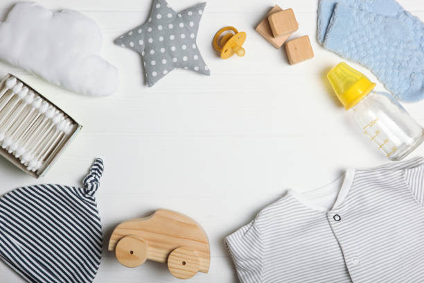 istock baby clothes on a colored background top view. Baby background 1277496182