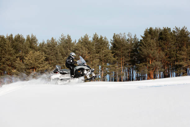 istock In deep powder snowdrift snowmobile rider driving fast. 1277497009