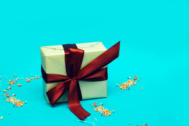 istock Christmas background with gift box isolated on blue, preparation for holidays 1277498789
