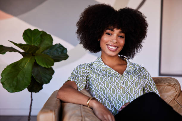 istock Young woman relaxing on a cafe sofa and smiling 1277499441