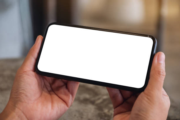 istock a woman holding mobile phone with blank white desktop screen 1277500377