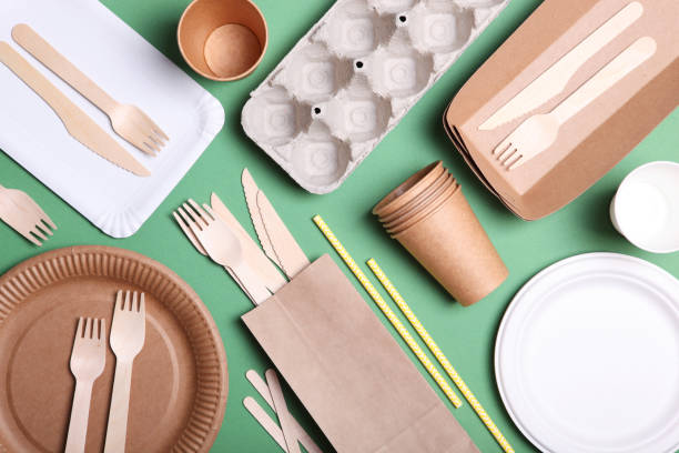 istock eco friendly dishes on a colored background top view. Eco-friendly disposable tableware. The concept of saving the planet, the rejection of plastic 1277500693