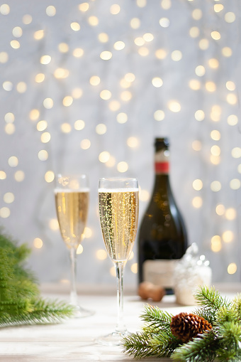 Glasses with champagne at new year christmas celebration table vertical image