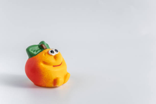 istock Children's rubber toy apple, on a white background. Side view. Development and games with children. Space for text. 1277503420
