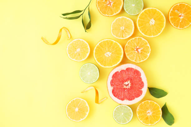 istock Different citrus and juicy slices on a colored background top view. Place to insert text. 1277503804