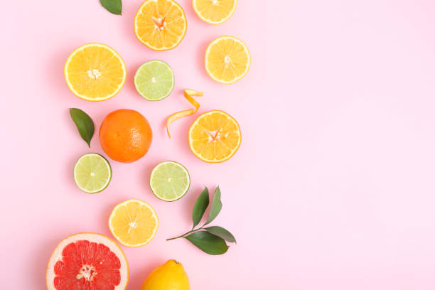 istock Different citrus and juicy slices on a colored background top view. Place to insert text. 1277503903