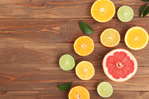 istock Different citrus and juicy slices on a colored background top view. Place to insert text. 1277503996