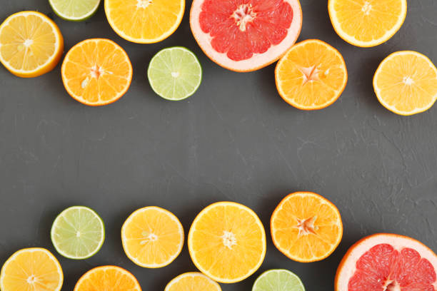 istock Different citrus and juicy slices on a colored background top view. Place to insert text. 1277504244