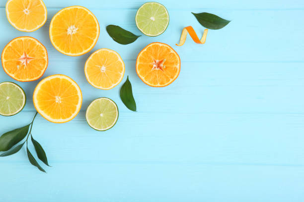 istock Different citrus and juicy slices on a colored background top view. Place to insert text. 1277505231