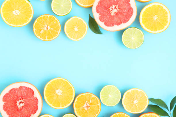 istock Different citrus and juicy slices on a colored background top view. Place to insert text. 1277505234