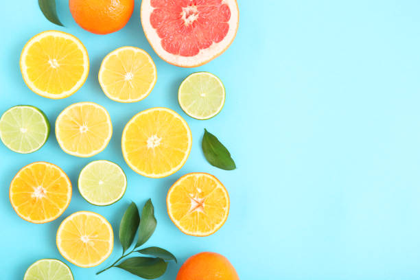 istock Different citrus and juicy slices on a colored background top view. Place to insert text. 1277505842