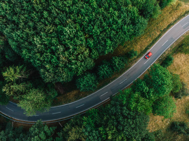 a road with a curve aerial view of a road with a curve at a forest hesse germany stock pictures, royalty-free photos & images