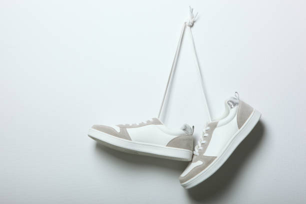 istock White women's gym shoes on a light background. 1277507679
