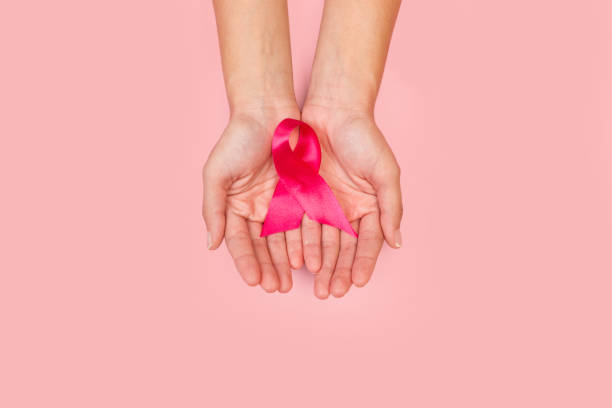 istock Woman hands holding a pink bow 1277507710