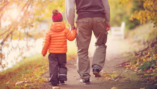 istock Child standing with umbrella in beautiful autumnal day 1277509392