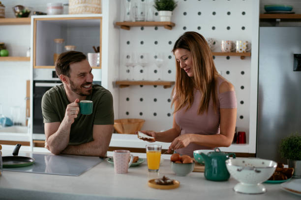 istock Young couple making breakfast at home. 1277510545