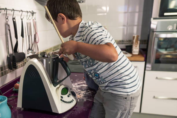 istock two children baking cake at home. 1277510828
